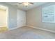 Neutral bedroom with ceiling fan and closet; plantation shutters adorn the large window at 4861 Antrim Dr, Sarasota, FL 34240