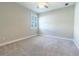 Cozy bedroom featuring neutral carpet, a ceiling fan, and plantation shutters for natural light at 4861 Antrim Dr, Sarasota, FL 34240
