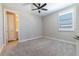 Bedroom with neutral carpet, ceiling fan, and an ensuite bathroom at 4861 Antrim Dr, Sarasota, FL 34240