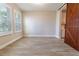 Spacious bedroom with natural light, wood-look floors, and a sliding barn door at 4861 Antrim Dr, Sarasota, FL 34240