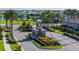 Gated community entrance with decorative landscaping, mature palms, and serene lake views at 4861 Antrim Dr, Sarasota, FL 34240