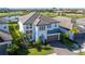 Beautiful two-story home with a two-car garage, brick driveway, and lush landscaping at 4861 Antrim Dr, Sarasota, FL 34240