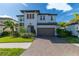 Beautiful two-story home with a brick driveway, well-manicured lawn, and a two-car garage at 4861 Antrim Dr, Sarasota, FL 34240