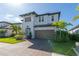 Charming two-story home with a brick driveway, lush landscaping, and a two-car garage at 4861 Antrim Dr, Sarasota, FL 34240