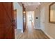 Grand foyer with wood-look tile flooring, sliding barn doors, and a view of the staircase at 4861 Antrim Dr, Sarasota, FL 34240