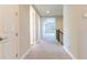 Carpeted hallway with multiple doorways and staircase, providing seamless transition between rooms at 4861 Antrim Dr, Sarasota, FL 34240