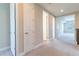 Upstairs hallway with carpet, showcasing doors leading to various rooms and ample natural light at 4861 Antrim Dr, Sarasota, FL 34240