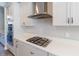 A close up of the kitchen with stainless steel range hood and gas cooktop at 4861 Antrim Dr, Sarasota, FL 34240