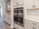 Kitchen showcases stainless steel built-in double ovens and stylish white cabinets at 4861 Antrim Dr, Sarasota, FL 34240