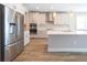 Modern kitchen with stainless steel refrigerator, white cabinets, and quartz countertop island at 4861 Antrim Dr, Sarasota, FL 34240