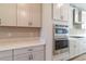 Kitchen includes stainless steel appliances, plenty of counter space, and white cabinets at 4861 Antrim Dr, Sarasota, FL 34240