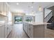 Open concept kitchen with stainless appliances, pendant lighting, and access to the outdoor living area at 4861 Antrim Dr, Sarasota, FL 34240