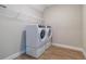 Modern laundry room featuring side-by-side washer and dryer with plenty of shelving and laminate wood-look flooring at 4861 Antrim Dr, Sarasota, FL 34240