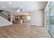 Open-concept living room showcasing wood-look tile floors and seamless flow into the kitchen area at 4861 Antrim Dr, Sarasota, FL 34240