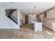Spacious living room showcases modern kitchen, a staircase, and stylish flooring at 4861 Antrim Dr, Sarasota, FL 34240