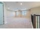 Spacious loft with plush carpeting and natural light, featuring a modern ceiling fan at 4861 Antrim Dr, Sarasota, FL 34240
