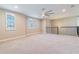Large, carpeted loft area with bright natural light and modern ceiling fan fixture at 4861 Antrim Dr, Sarasota, FL 34240
