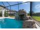Screened pool area featuring a custom rock waterfall that adds a natural touch to the outdoor oasis at 4861 Antrim Dr, Sarasota, FL 34240