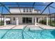 Covered outdoor space overlooks a screened pool and spa combo for seamless indoor-outdoor living at 4861 Antrim Dr, Sarasota, FL 34240