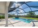 Covered outdoor space overlooks a screened pool, spa, and rock waterfall at 4861 Antrim Dr, Sarasota, FL 34240