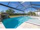 A screened pool and spa with a rock waterfall feature enhance the outdoor living experience at 4861 Antrim Dr, Sarasota, FL 34240