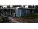 Quaint home featuring blue siding, lattice accents, and a charming garden bed, perfect for relaxed outdoor living at 6505 Oelsner St, New Port Richey, FL 34652