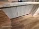 Stylish kitchen island with granite countertop and white cabinets, blending functionality and elegance at 6505 Oelsner St, New Port Richey, FL 34652