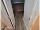 A walk-in closet with wood-look vinyl flooring, perfect for ample storage and organization at 6505 Oelsner St, New Port Richey, FL 34652