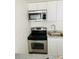 Bright kitchen featuring stainless steel appliances, white cabinets, and modern countertops at 8612 N Alaska St, Tampa, FL 33604