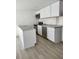 Bright kitchen featuring stainless steel appliances, white cabinets, and modern countertops at 8612 N Alaska St, Tampa, FL 33604
