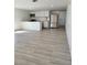 Bright living room featuring a kitchen with stainless steel appliances, white cabinets, and modern countertops, plus updated floors at 8612 N Alaska St, Tampa, FL 33604