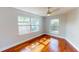 Bedroom with hardwood floors, ceiling fan and natural light from dual windows at 2456 S 17Th S Ave, St Petersburg, FL 33712