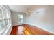 Sunlit bedroom with gleaming wood floors, a ceiling fan, and dual windows offering natural light at 2456 S 17Th S Ave, St Petersburg, FL 33712