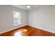 Well-lit bedroom featuring hardwood floors, a large window providing natural light and fresh trim at 2456 S 17Th S Ave, St Petersburg, FL 33712