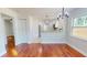 Inviting dining area with modern chandelier, hardwood floors, and convenient access to the stylish kitchen at 2456 S 17Th S Ave, St Petersburg, FL 33712