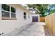 Exterior shot of a charming white home with a brown garage, side entrance and privacy fence at 2456 S 17Th S Ave, St Petersburg, FL 33712