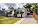 Beautiful home exterior featuring manicured lawn, decorative landscaping, and a long driveway with garage at 2456 S 17Th S Ave, St Petersburg, FL 33712
