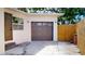 View of attached garage, next to a partial fence and next to the side entrance at 2456 S 17Th S Ave, St Petersburg, FL 33712