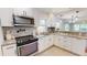 Kitchen featuring stainless appliances, stone counter tops and white cabinetry at 2456 S 17Th S Ave, St Petersburg, FL 33712