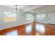 Bright living space with sleek hardwood floors, a modern chandelier, and a large window at 2456 S 17Th S Ave, St Petersburg, FL 33712