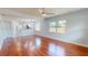 Spacious living room with gleaming hardwood floors, large windows, and an open view to the updated kitchen at 2456 S 17Th S Ave, St Petersburg, FL 33712