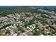 Wide angle aerial view of a residential neighborhood with tree-lined streets and varied home styles at 7337 Cone Shell Dr, Spring Hill, FL 34607