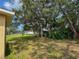 Green backyard space with a view of neighboring houses at 7337 Cone Shell Dr, Spring Hill, FL 34607