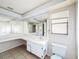 Bright bathroom with double sinks, tile floors, a toilet, and window at 7337 Cone Shell Dr, Spring Hill, FL 34607