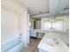 Bathroom featuring a bathtub and a double sink vanity with a wide mirror at 7337 Cone Shell Dr, Spring Hill, FL 34607