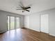 Cozy bedroom with wood floors, natural light, and closet space at 7337 Cone Shell Dr, Spring Hill, FL 34607