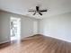 Spacious bedroom featuring wood floors and an en suite bathroom at 7337 Cone Shell Dr, Spring Hill, FL 34607