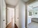Hallway featuring wood floors leading to bedroom and bathroom at 7337 Cone Shell Dr, Spring Hill, FL 34607