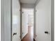 Hallway with doors to bedrooms and closets, with wood flooring at 7337 Cone Shell Dr, Spring Hill, FL 34607