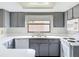 Kitchen showcasing gray cabinets, white appliances, and ample counter space at 7337 Cone Shell Dr, Spring Hill, FL 34607